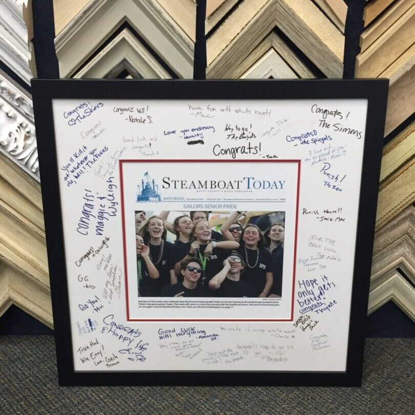 IMG_1765 Framed newspaper page with handwritten messages.
